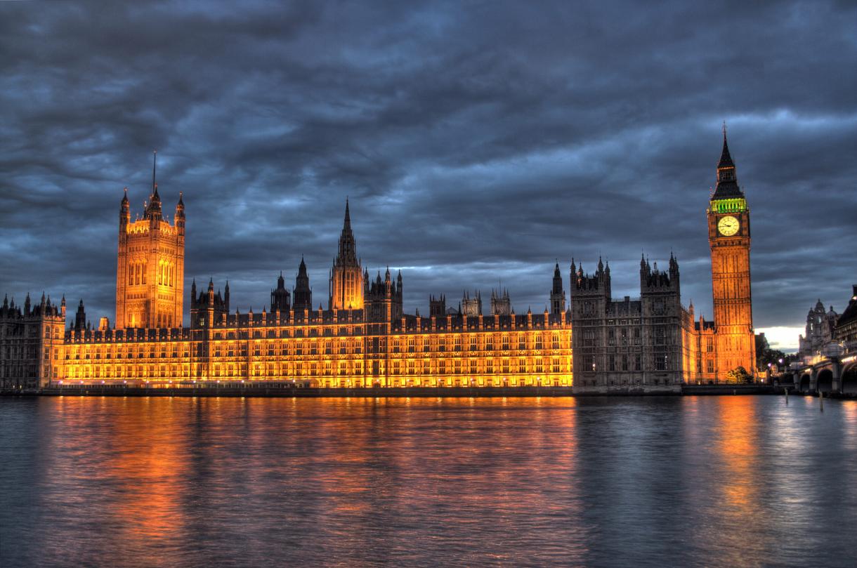 Photograph of the Palace of Westminster at dusk, taken from the south bank of the River Thames.